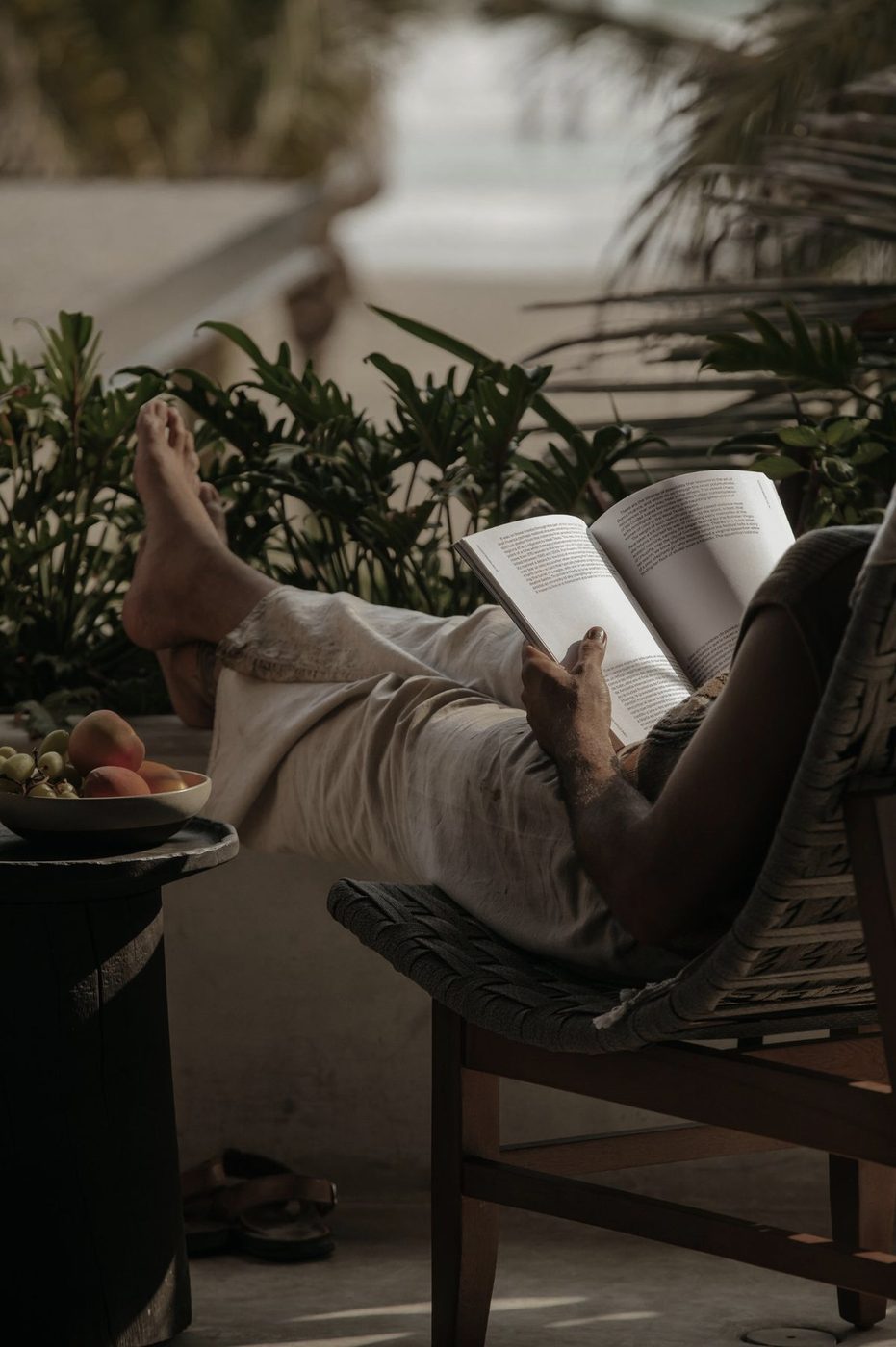A client at home in a finished Decopatio garden lounge — coffee, book, morning light
