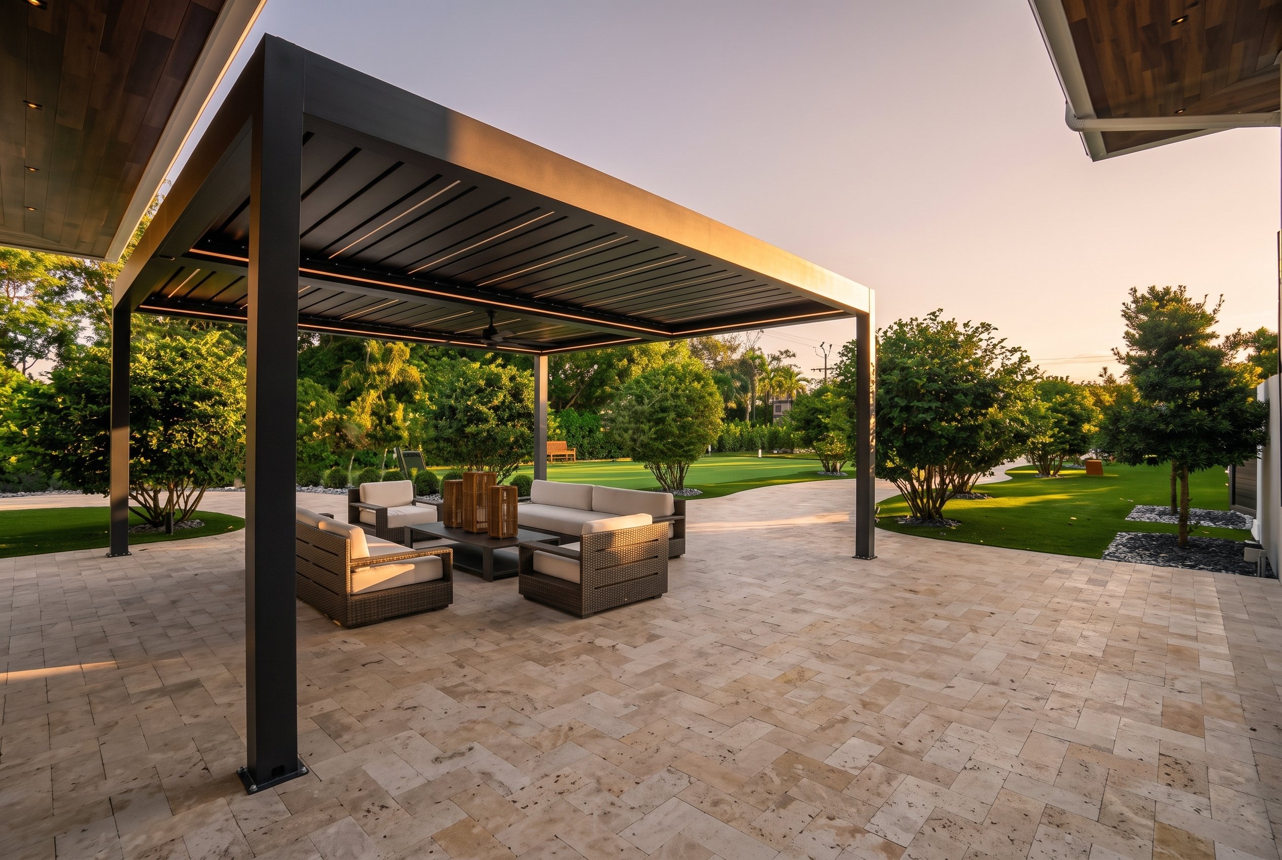 Bioclimatic louvered pergola over the lounge on the travertine terrace at golden hour