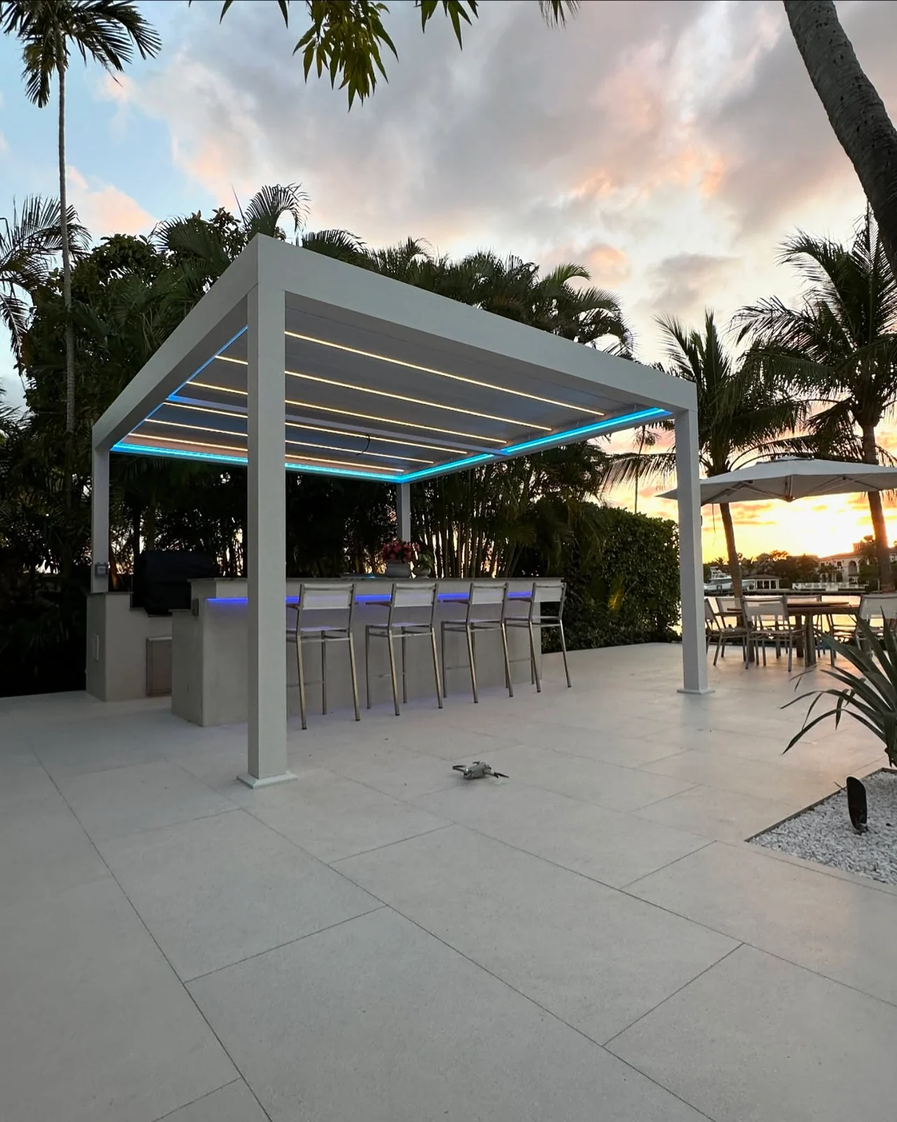 Bal Harbour pergola with blue perimeter lighting in the evening