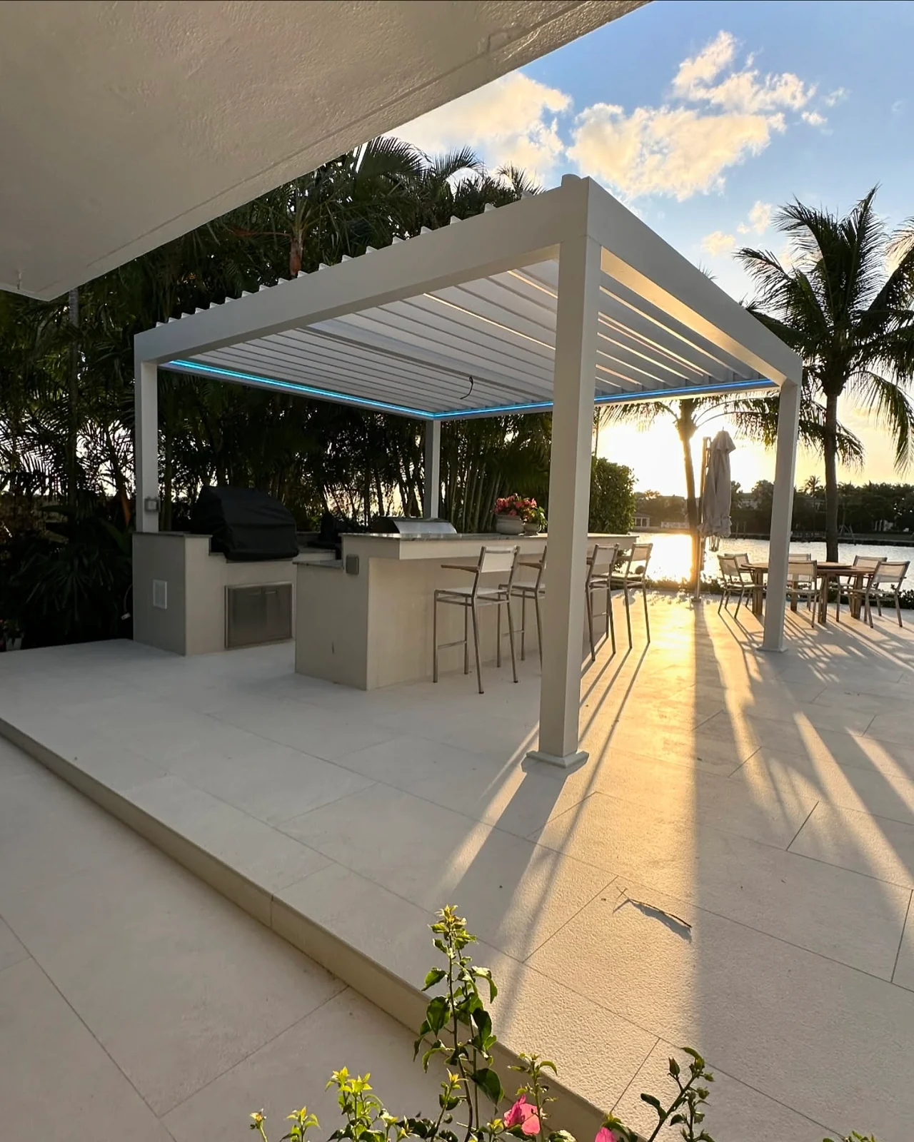 White louvered pergola over an outdoor kitchen and bar in Bal Harbour