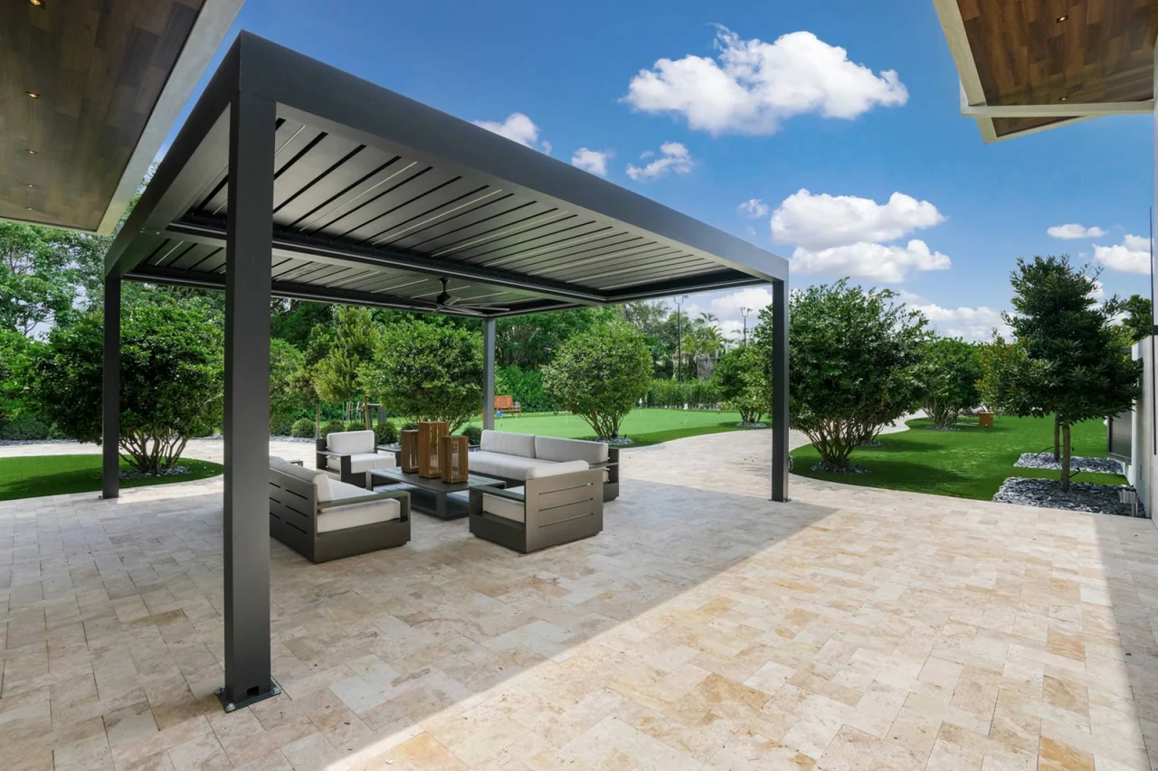 Dark pergola over the stone terrace and lounge at Casa Maranello