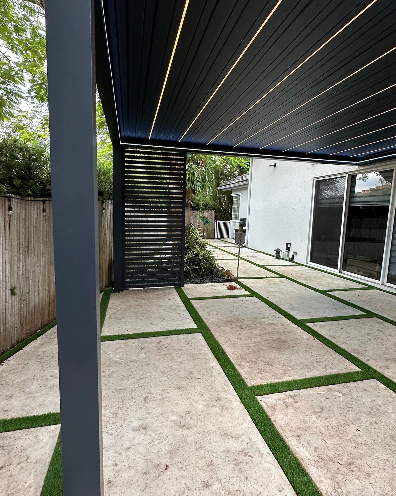 Integrated linear lighting within the charcoal Miramar pergola roof